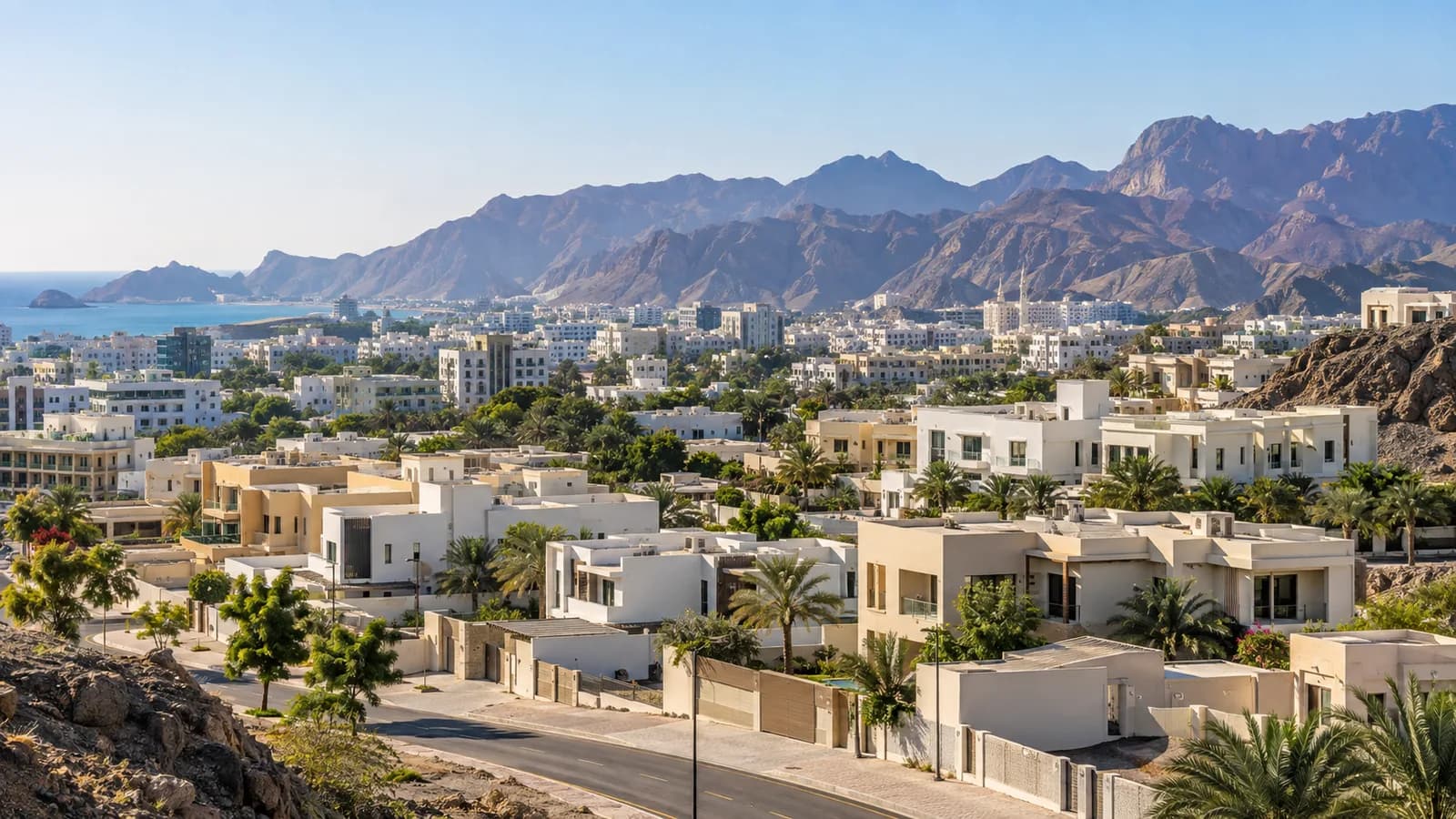 Residential buildings in Muscat with mountains beyond