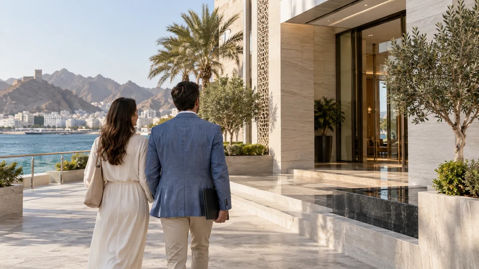 Couple arriving at a Muscat waterfront residence